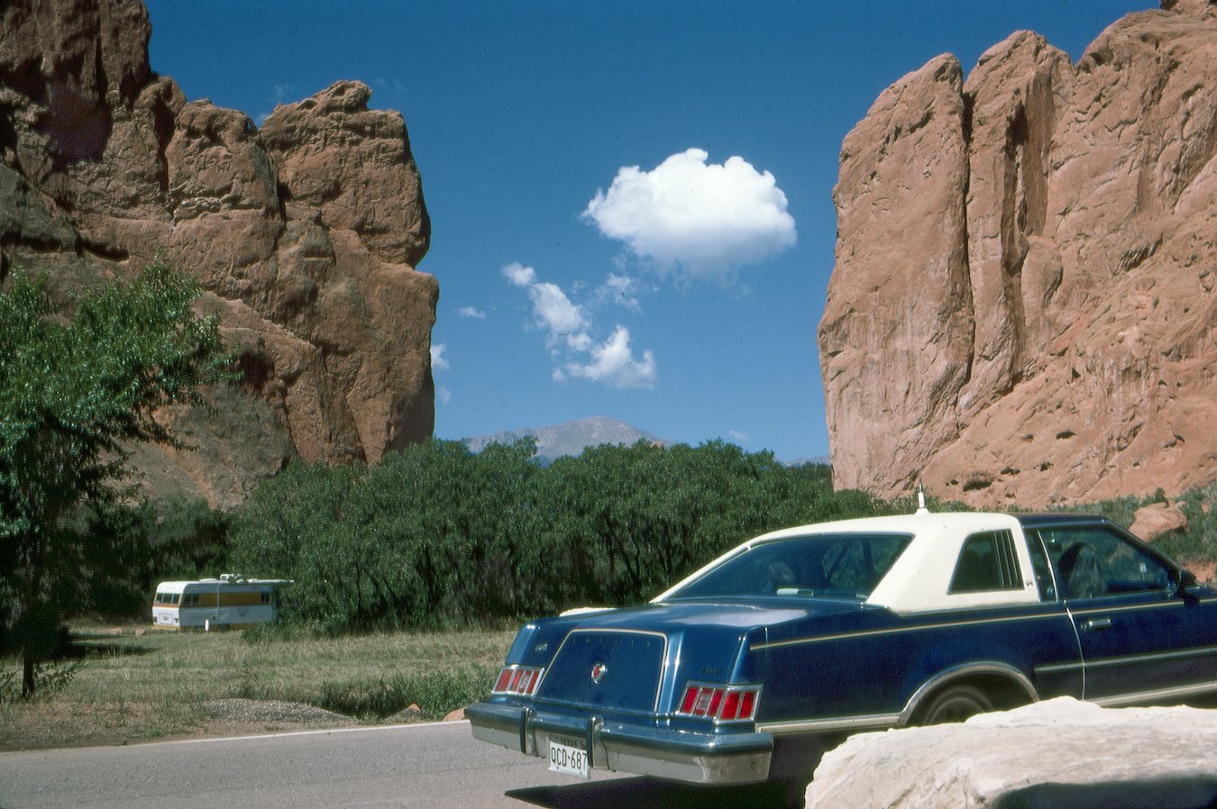 Cars driving the gateway to the Garden of the Gods, Colorado, 1977.