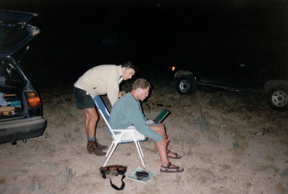 Kyle and Byron checking images on laptop, Wyoming 1997